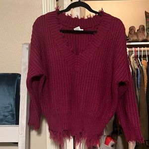 Purple sweater with fraying detail at edges